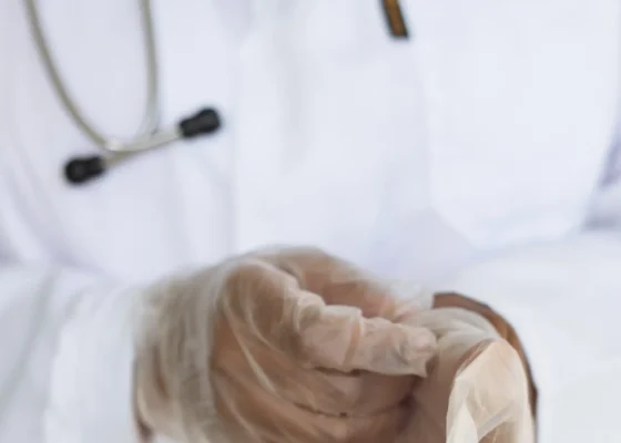 a zoomed in image of a healthcare worker wearing clothes and a white coat, with improved care skills