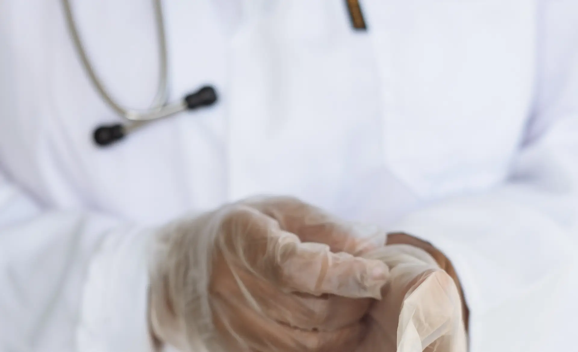 a zoomed in image of a healthcare worker wearing clothes and a white coat, with improved care skills