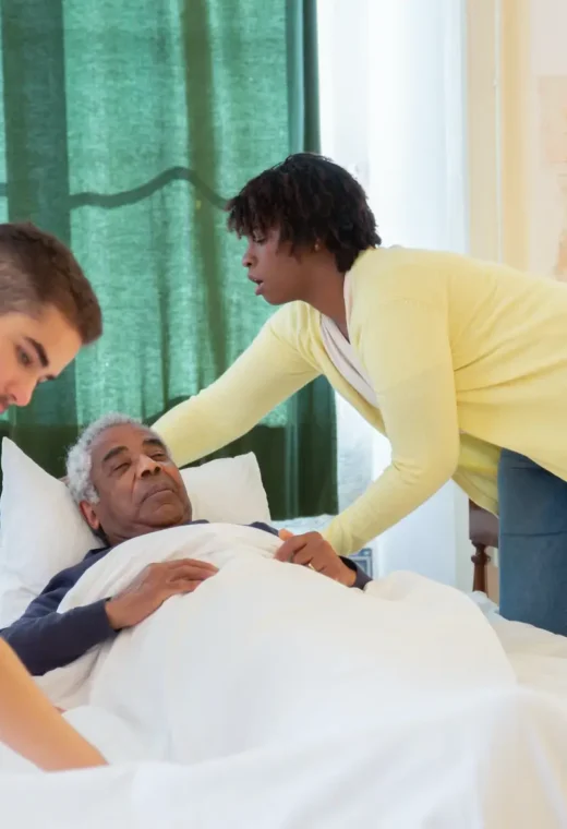 an image of two healthcare staff caring for a patient