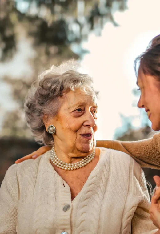 a care worker with her arm round a patient showing strong care worker skills