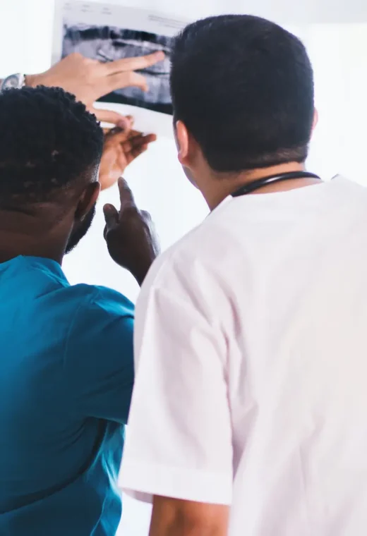 3 people who have a career in healthcare looking at an xray