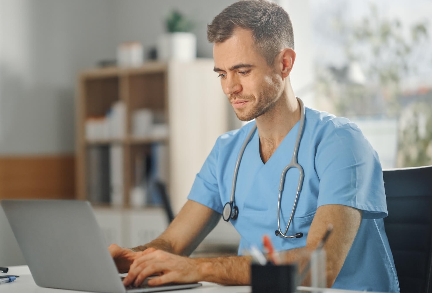 a children's services staffing professional reviewing work on their laptop