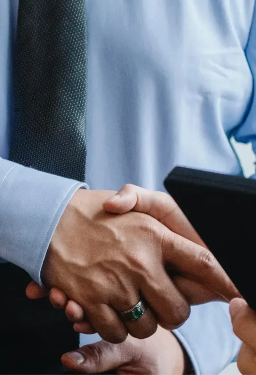 a zoomed in image of two people shaking hands