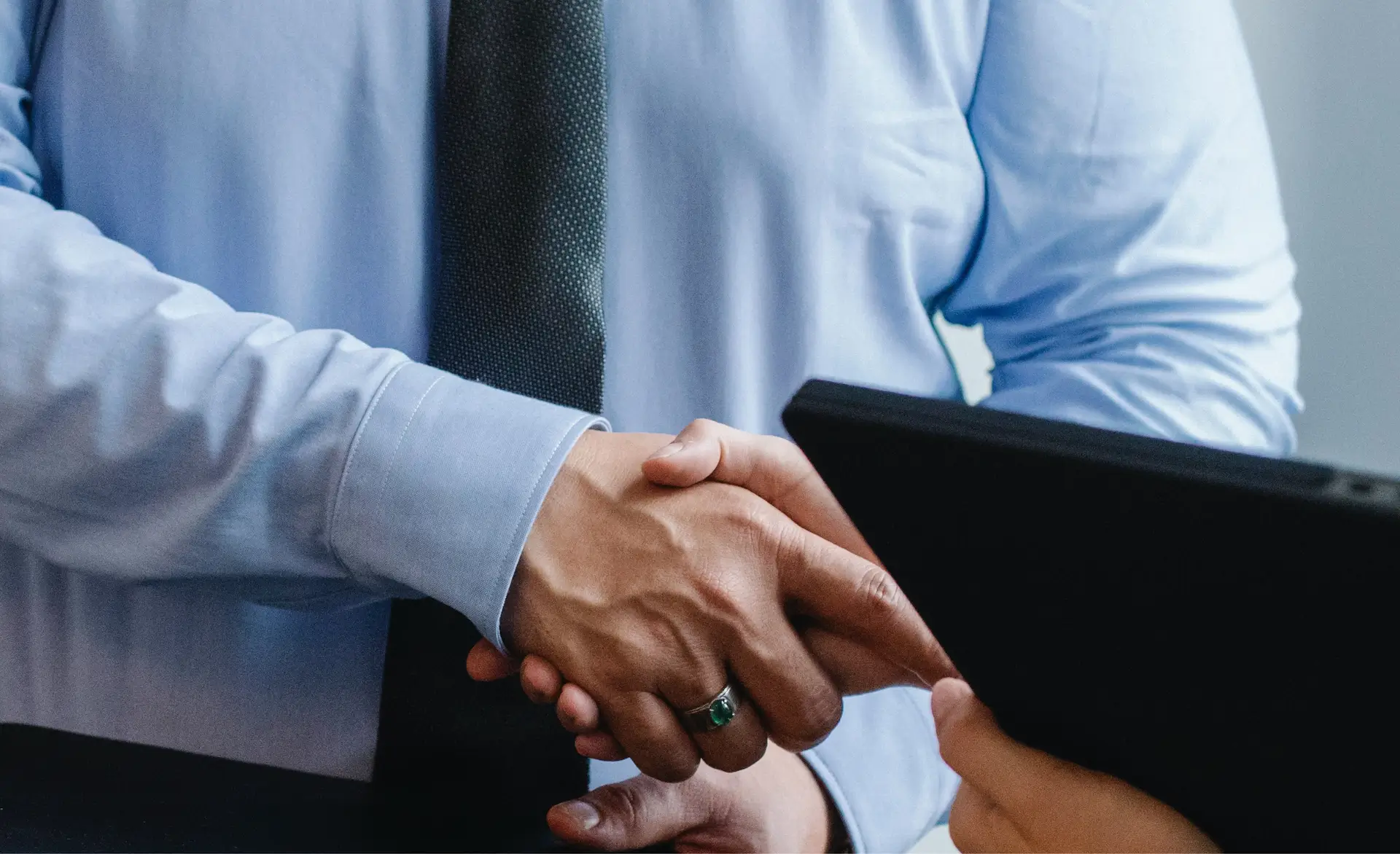 a zoomed in image of two people shaking hands