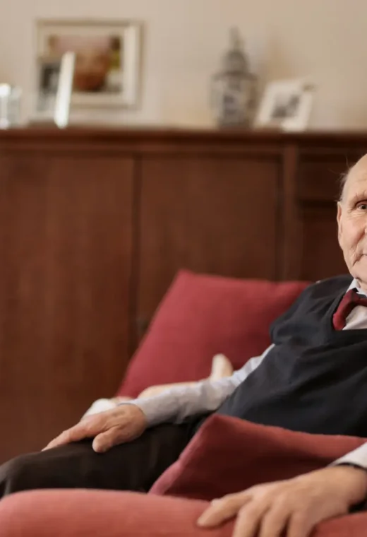 image of an elderly gentleman sitting in an armchair in a care home