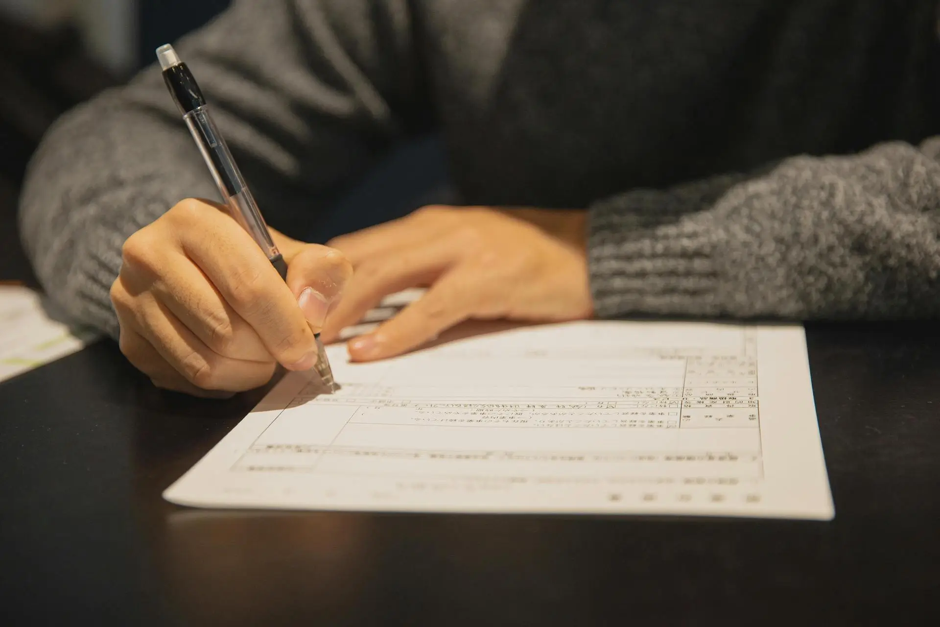 image of a person filling out a health and care worker visa form