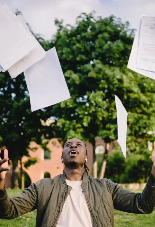 an image of someone throwing their documents in the air after a successful healthcare interview