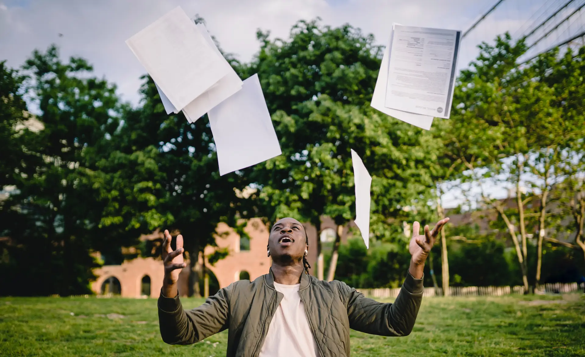 an image of someone throwing their documents in the air after a successful healthcare interview