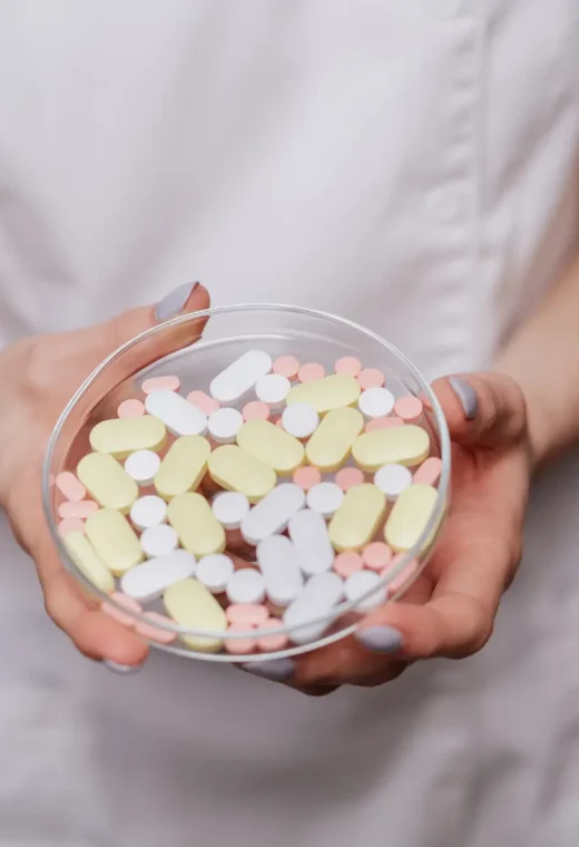a healthcare assistant holding prescription pills