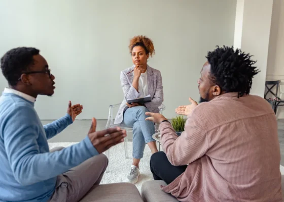 an image of 3 healthcare staff having a discussion