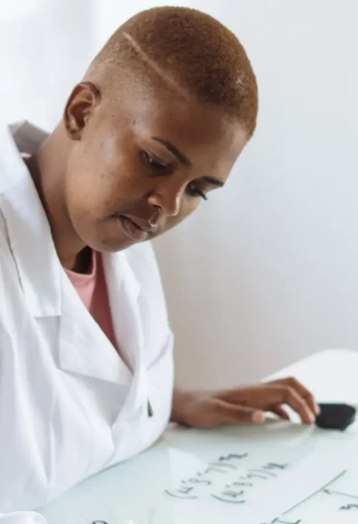 a healthcare professional writing on a whiteboard