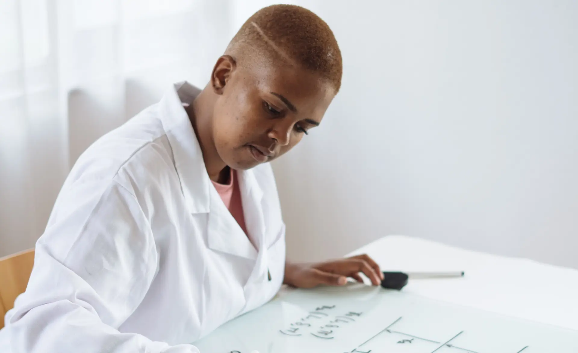 a healthcare professional writing on a whiteboard