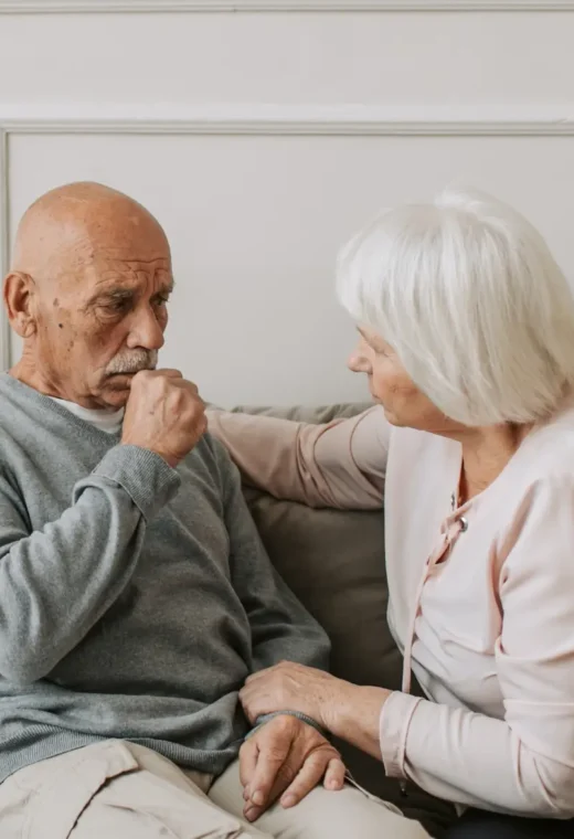 An older couple sat together talking intently