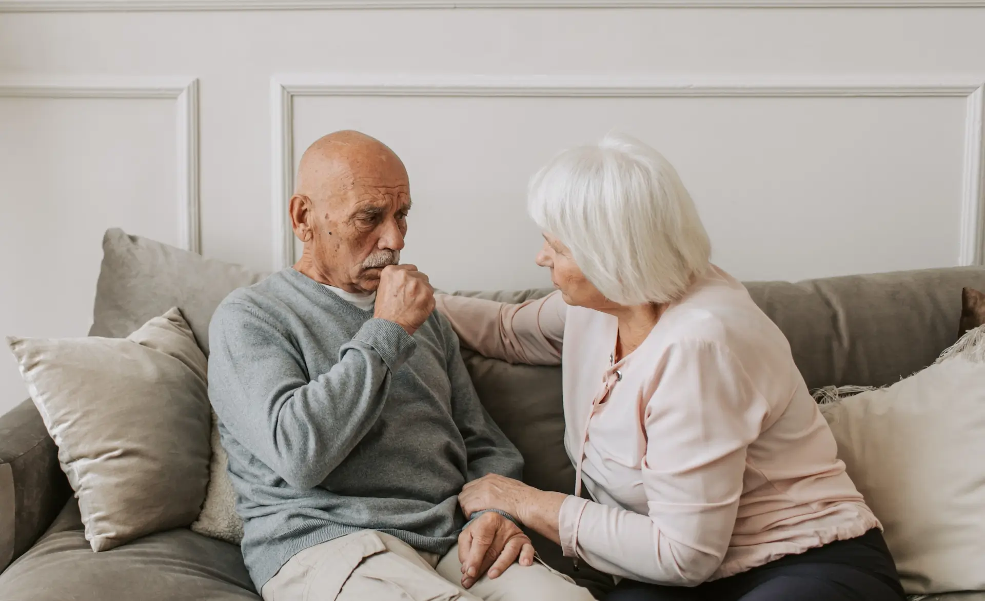 An older couple sat together talking intently