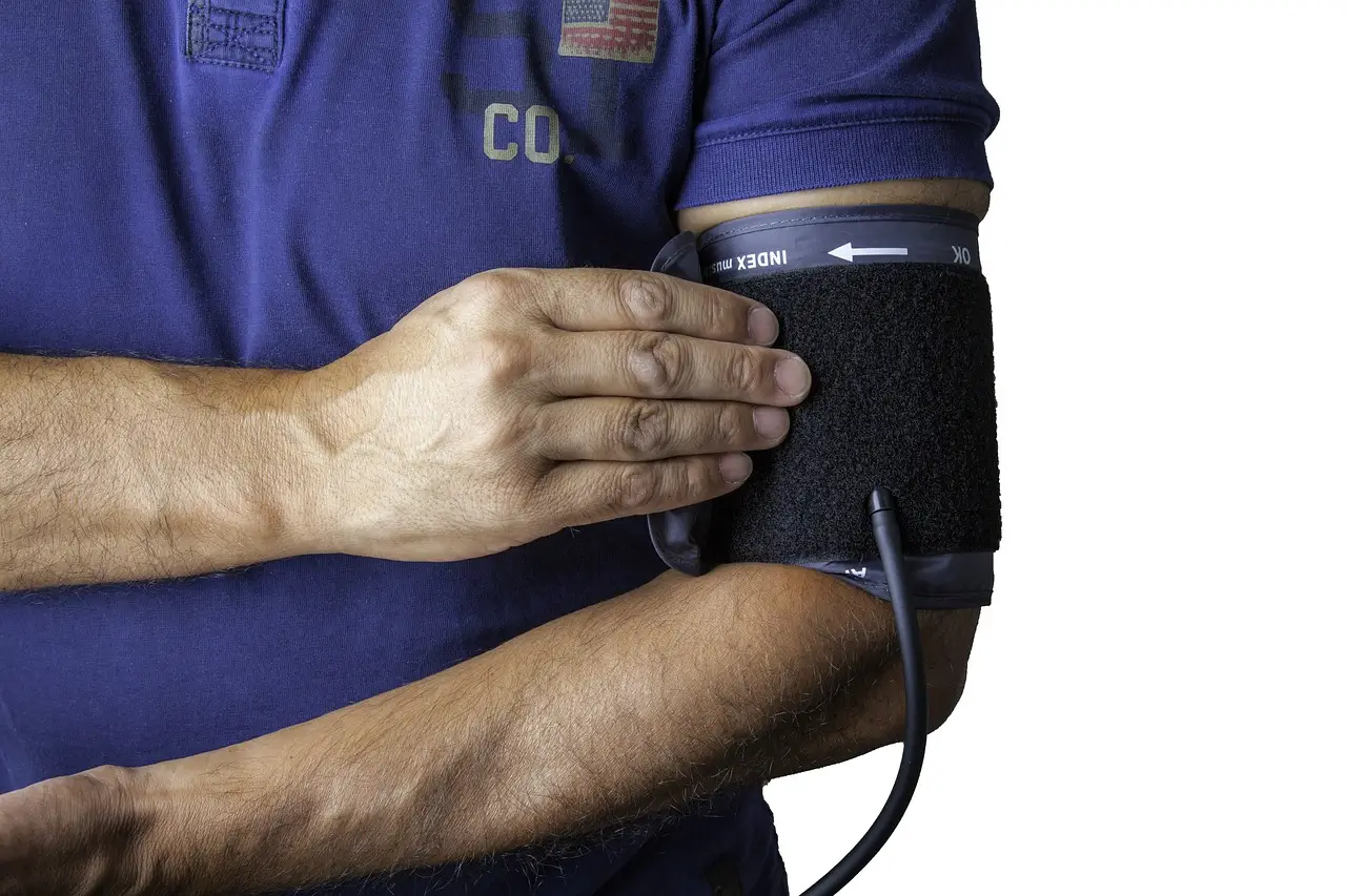 zoomed in image of an international healthcare assistant using a sphygmomanometer on themself