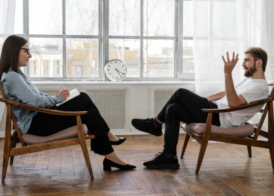 an image of a mental health support worker sat with a patient