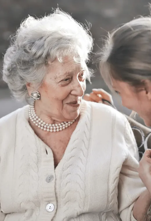 an image of a carer and a patient talking and smiling representing person-centred care