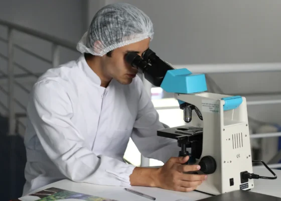 a healthcare professional at work using a microscope