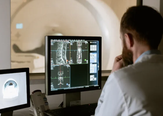 a man sat at a desk showing how technology in healthcare is used
