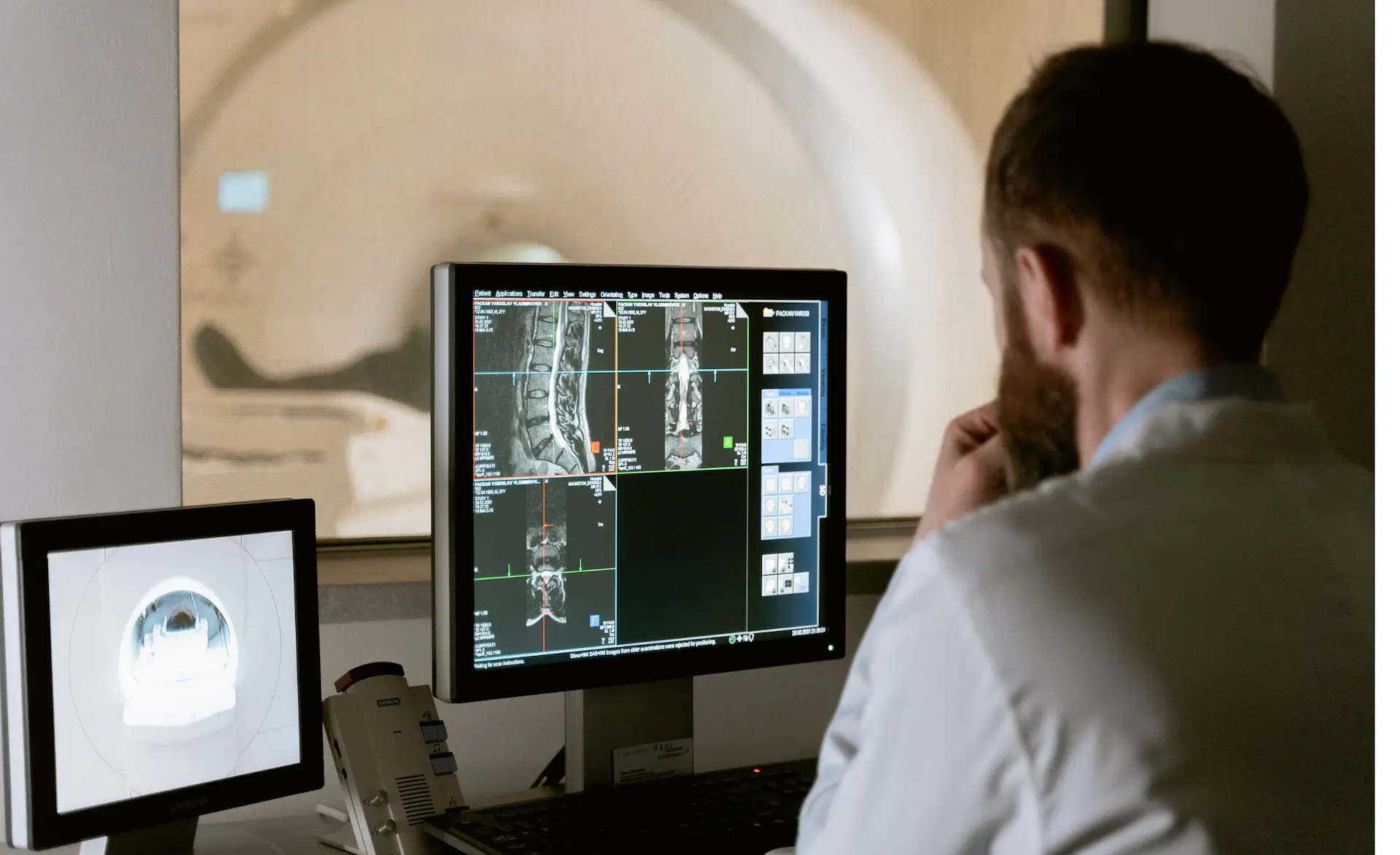 a man sat at a desk showing how technology in healthcare is used