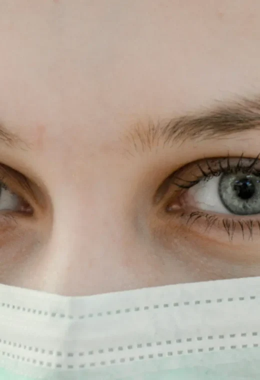 close up image of a face of a healthcare professional wearing PPE