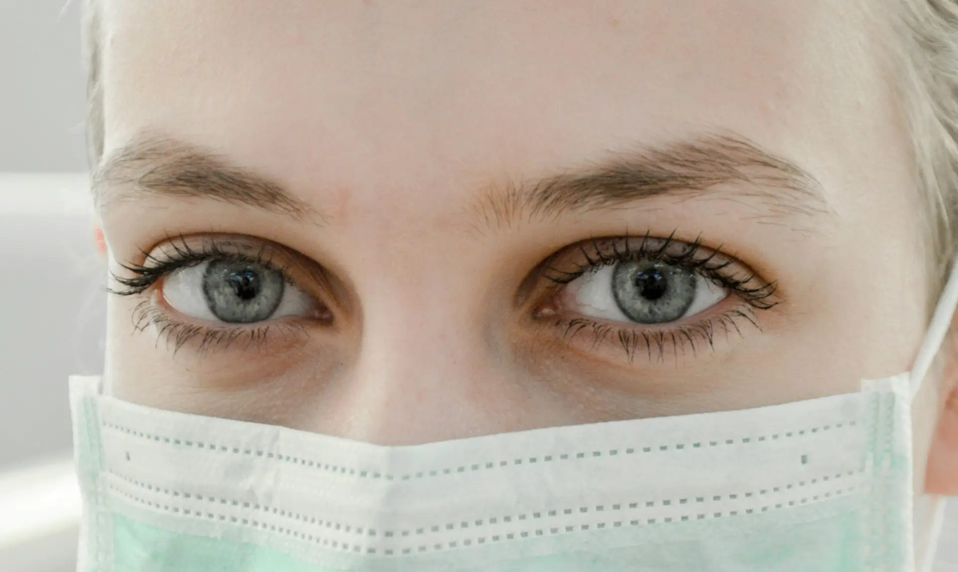 close up image of a face of a healthcare professional wearing PPE