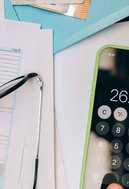 a healthcare professional calculating the cost of living crisis on healthcare facilities