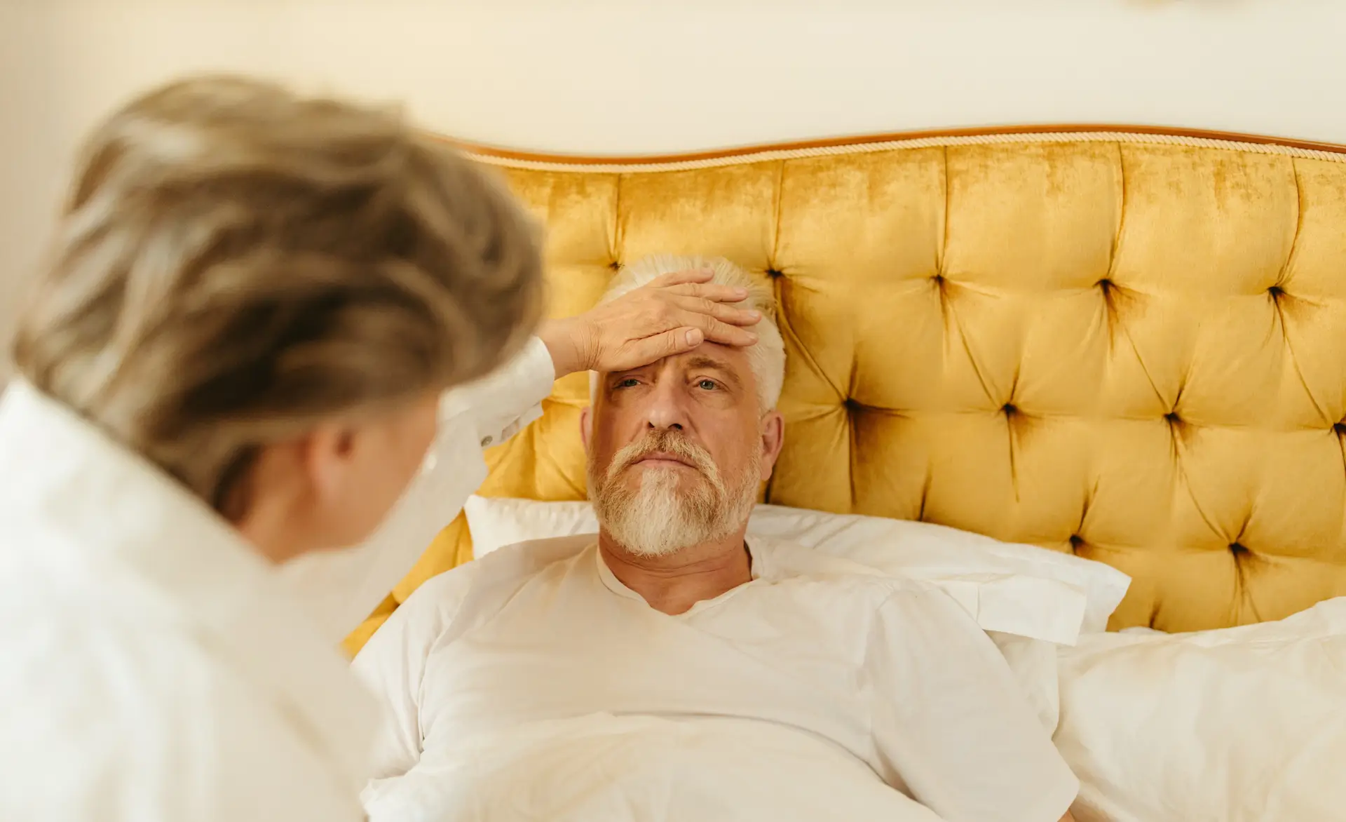 a woman caring for an elderly gentleman