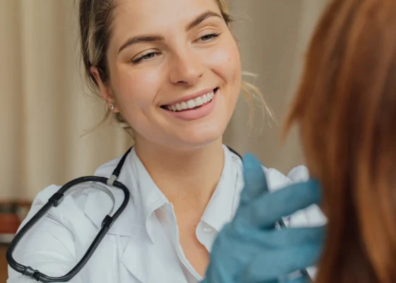 a nurse with a smile on her face showing the importance of healthcare workers pay