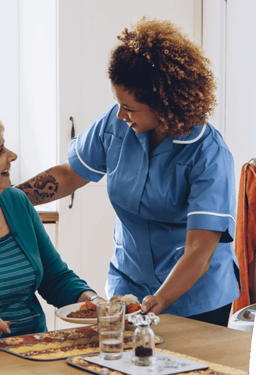 Carer showing how to solve a skills gap in care homes