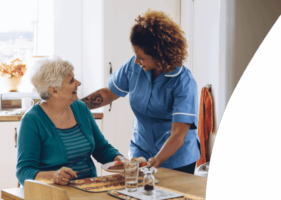 Carer showing how to solve a skills gap in care homes