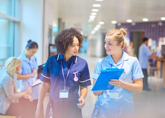 Two agency nurses in a hospital showing the agency nurse grades